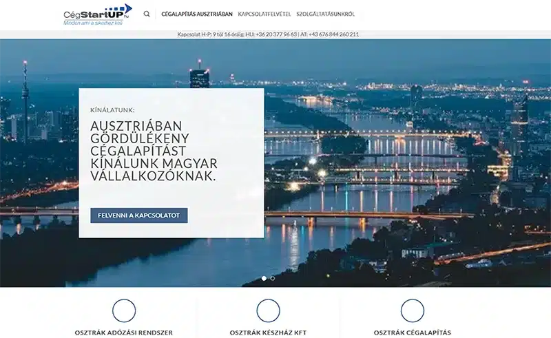 Panorama von Wien bei Nacht mit Fokus auf die Donau und die Stadtlichter, im Vordergrund eine Werbeeinblendung für Unternehmensgründungsdienstleistungen in Österreich. Professionelles Webdesign und Homepage-